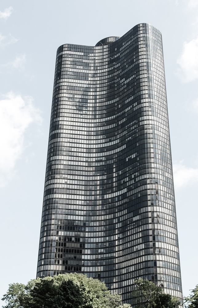 The curved dark glass of Lake Point Tower beside Navy Pier